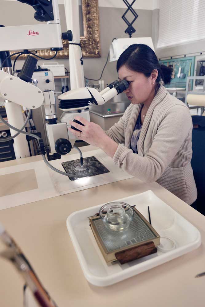 A women looking into a microscope