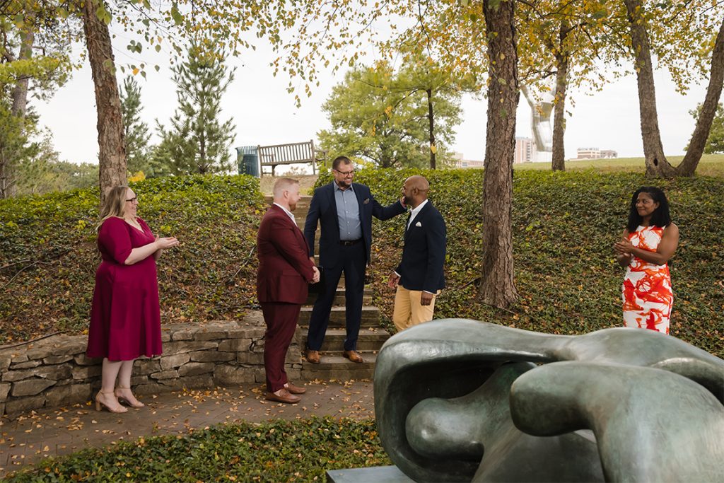 Small ceremony with five people taking place in the Sculpture Garden at the Nelson Atkins Museum of Art