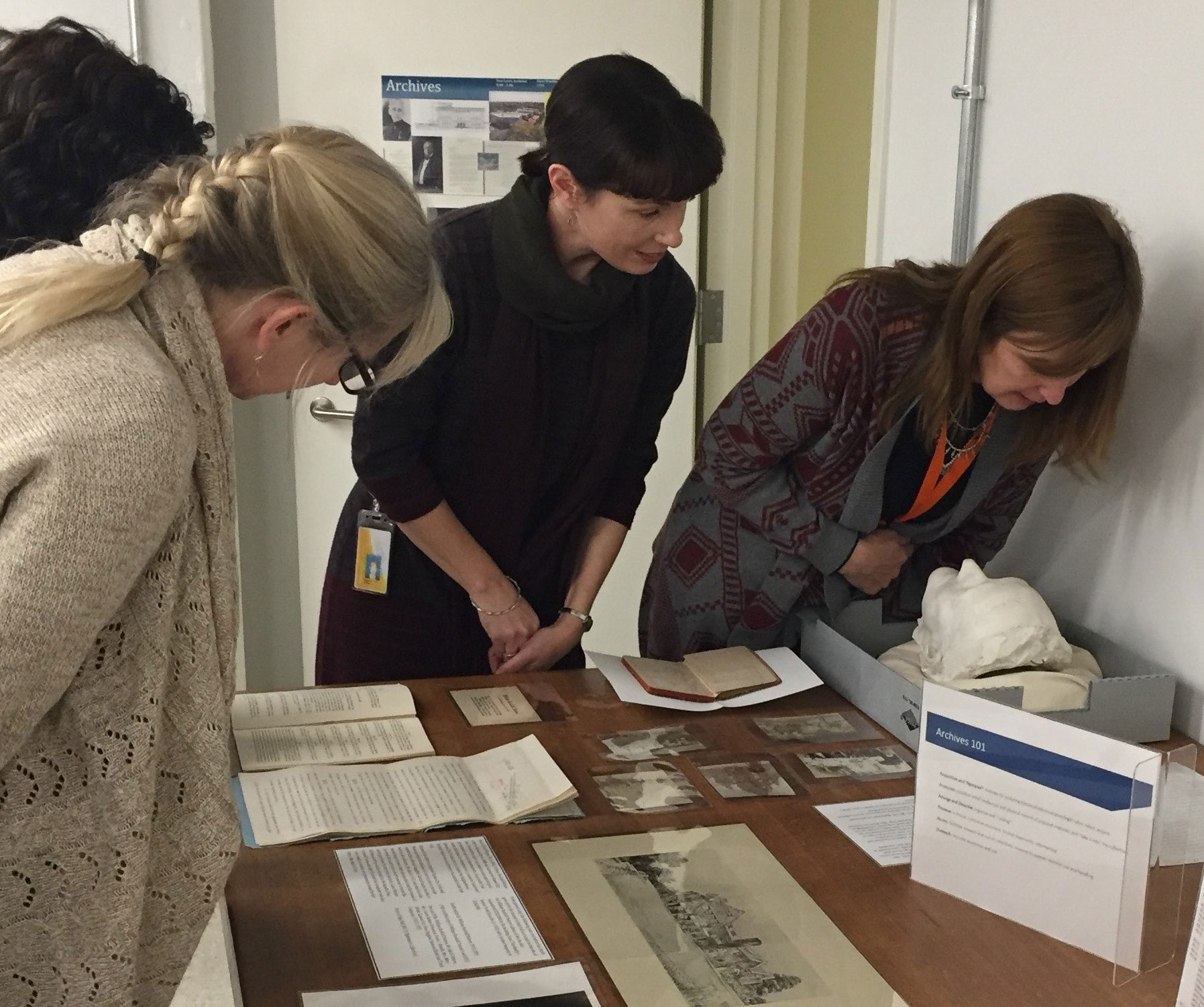 Group of people looking over materials from library archives