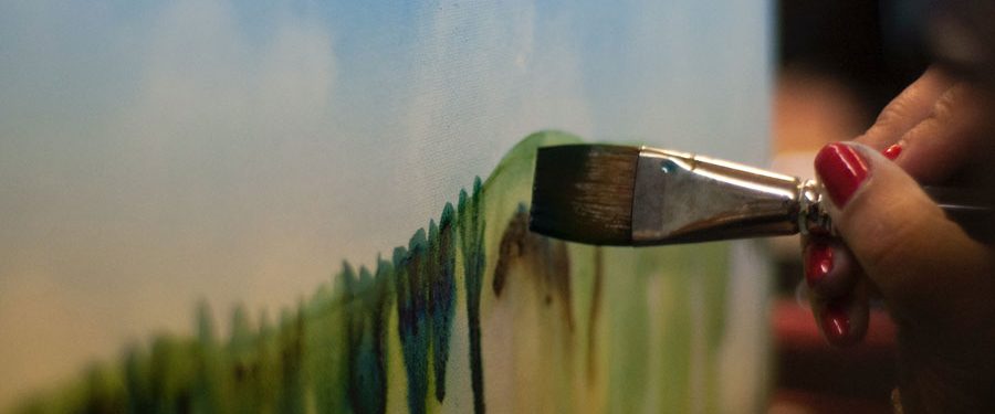 Close-up of paintbrush painting with green paint