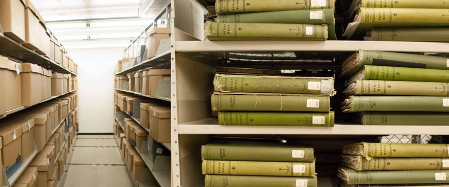 Shelves of archival boxes and books