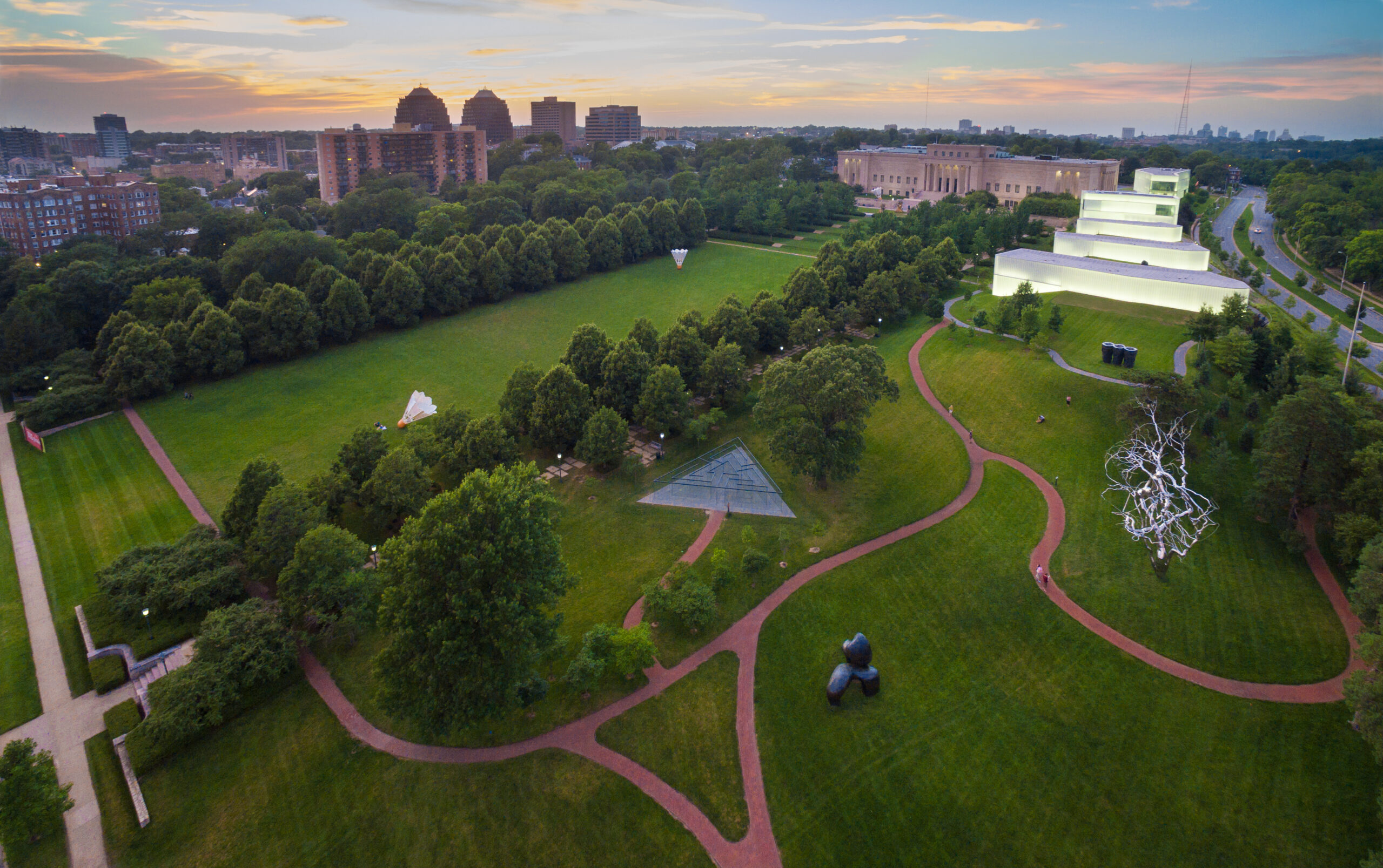 Drone view of the sculpture park with view of the glass labyrinth, lawn, pathways, and buildings.