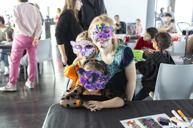 Three children wear handcrafted masks