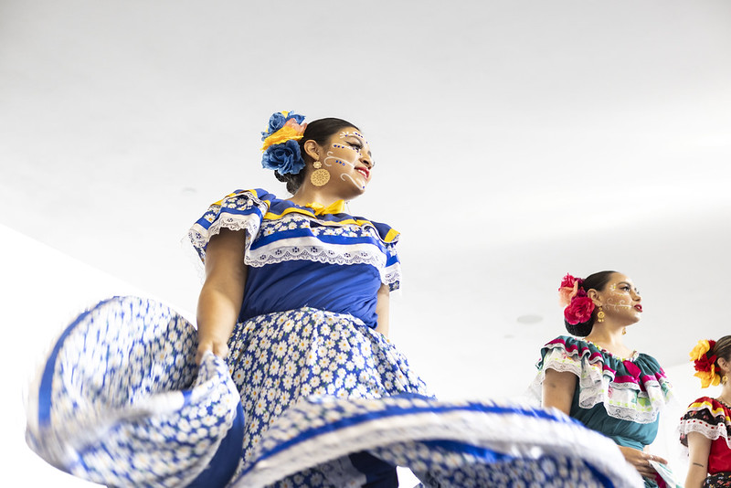 A woman in a blue dress spins