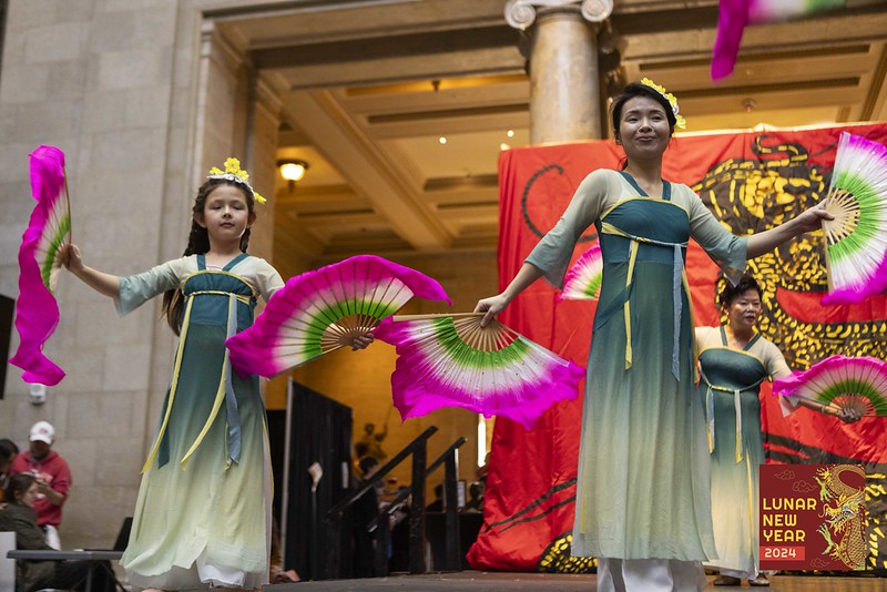 Two women perform with fans