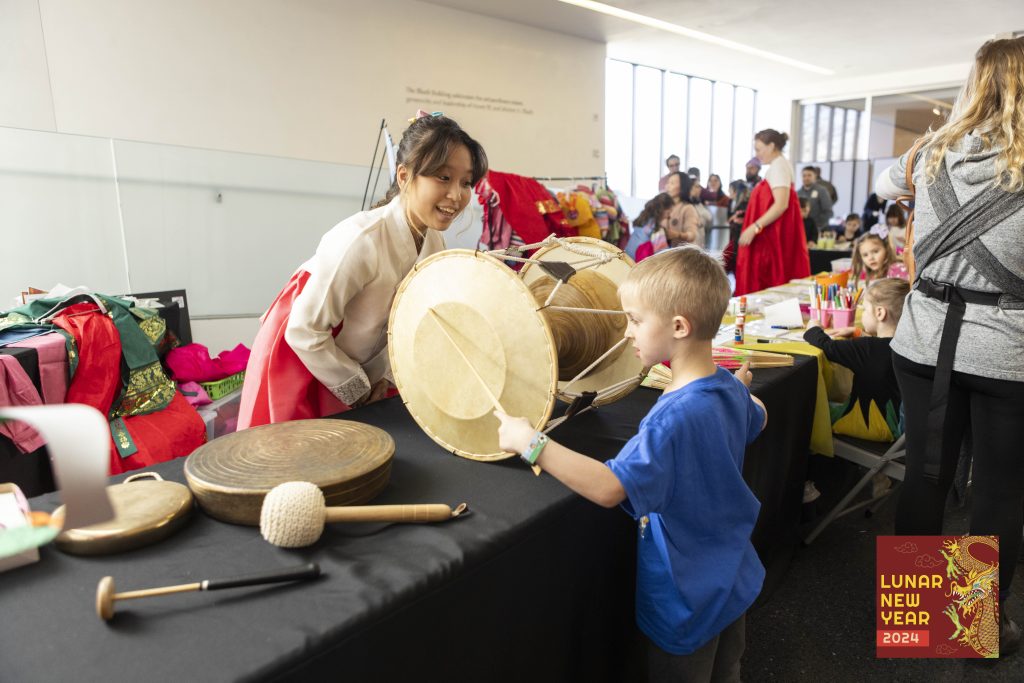 Image of a child and smiling woman with musical instruments