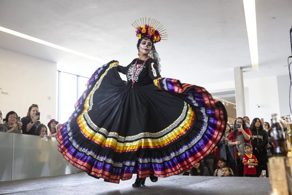 A performer in traditional dresses dances at the Nelson-Atkins Museum of Art's Dia de los Muertos festival.