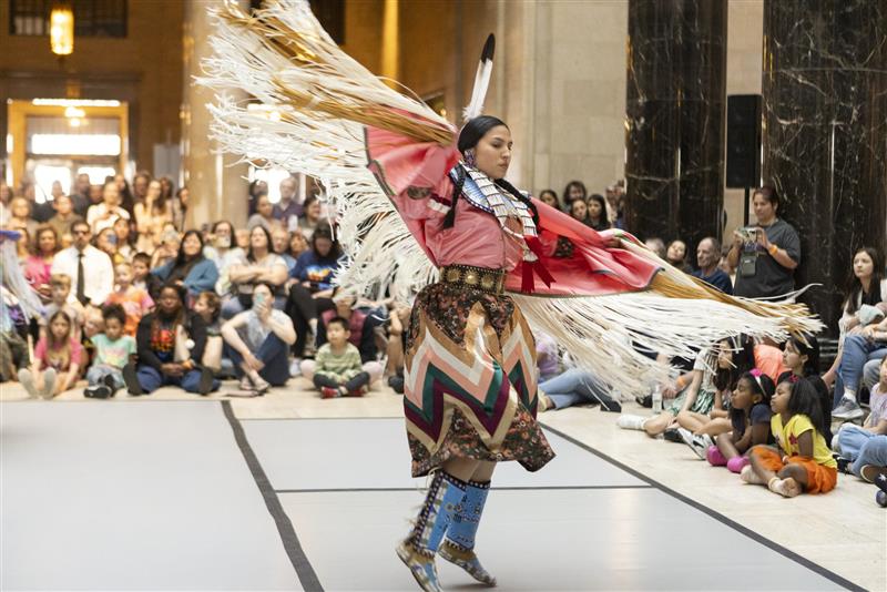 Woman in traditional native american clothing dancing.