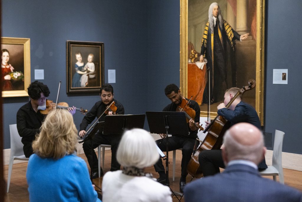 Society of Fellows members enjoy a live in-gallery performance by concert musicians.