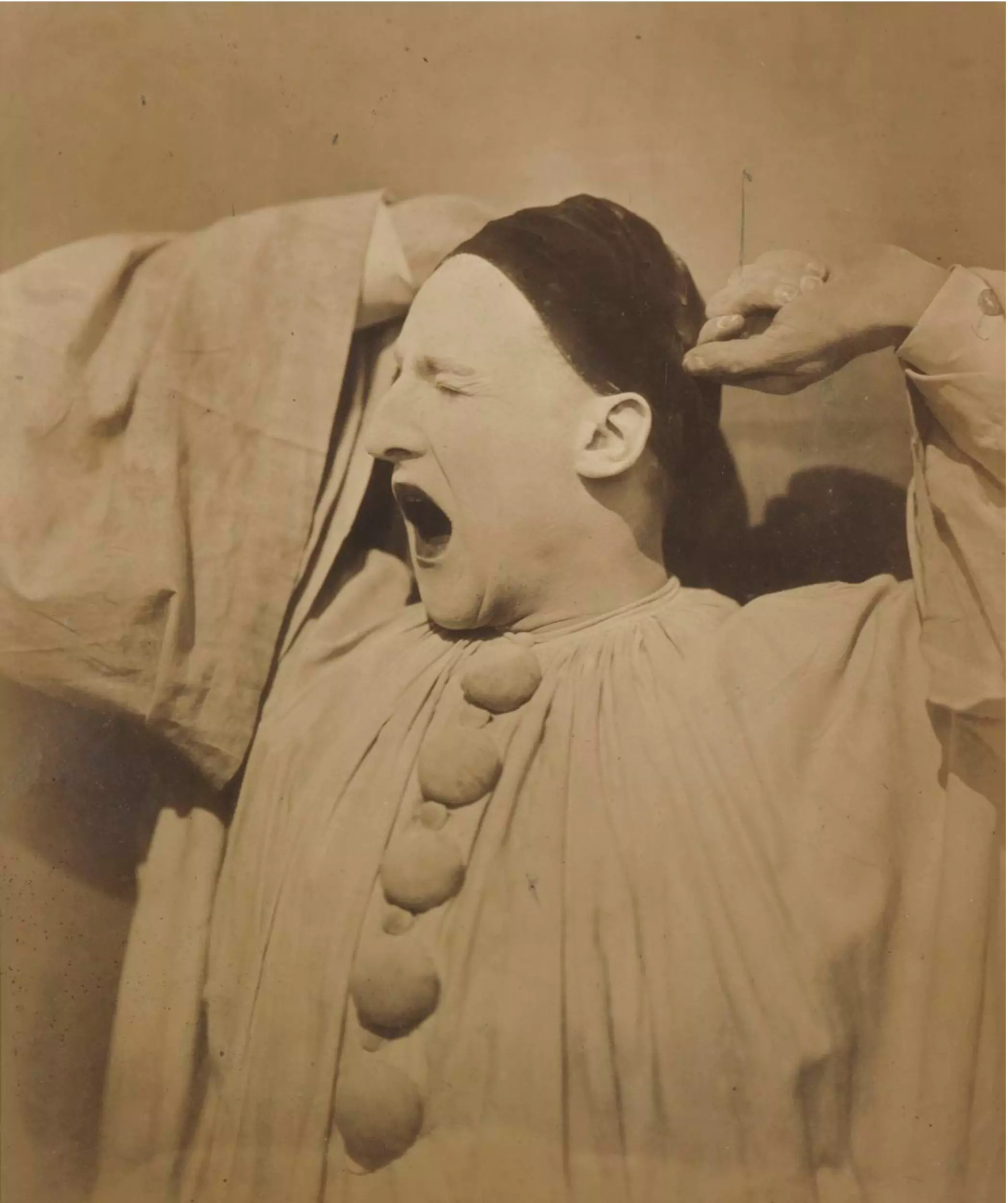 Adrien Tournachon, French (1825–1903) and Nadar [Gaspard Félix Tournachon], French (1820–1910). Pierrot Yawning, 1854. Salt print, 11 1/4 × 8 1/2 inches. The Nelson-Atkins Museum of Art, Gift of the Hall Family Foundation, 2017.61.39.