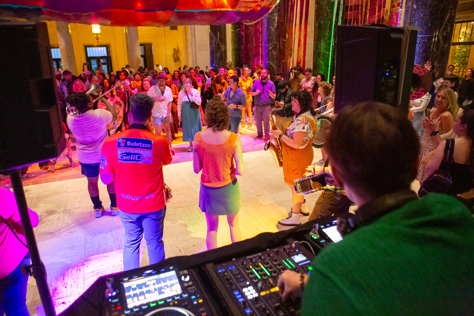 A brass band plays in front of a crowd at the Nelson-Atkins Night/Shift event.