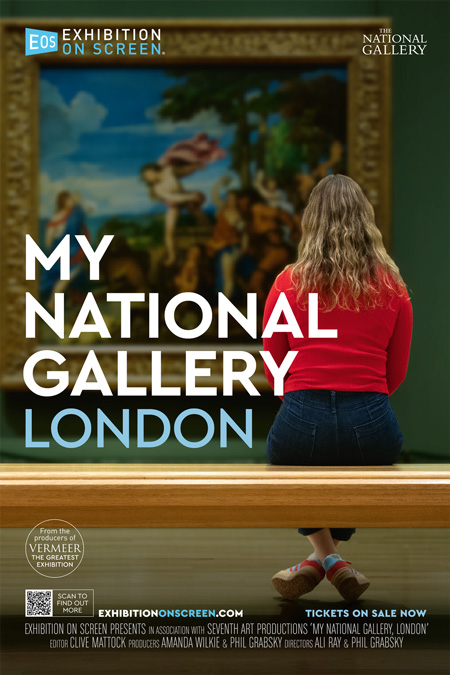 A woman sits on a bench in front of art in a museum.