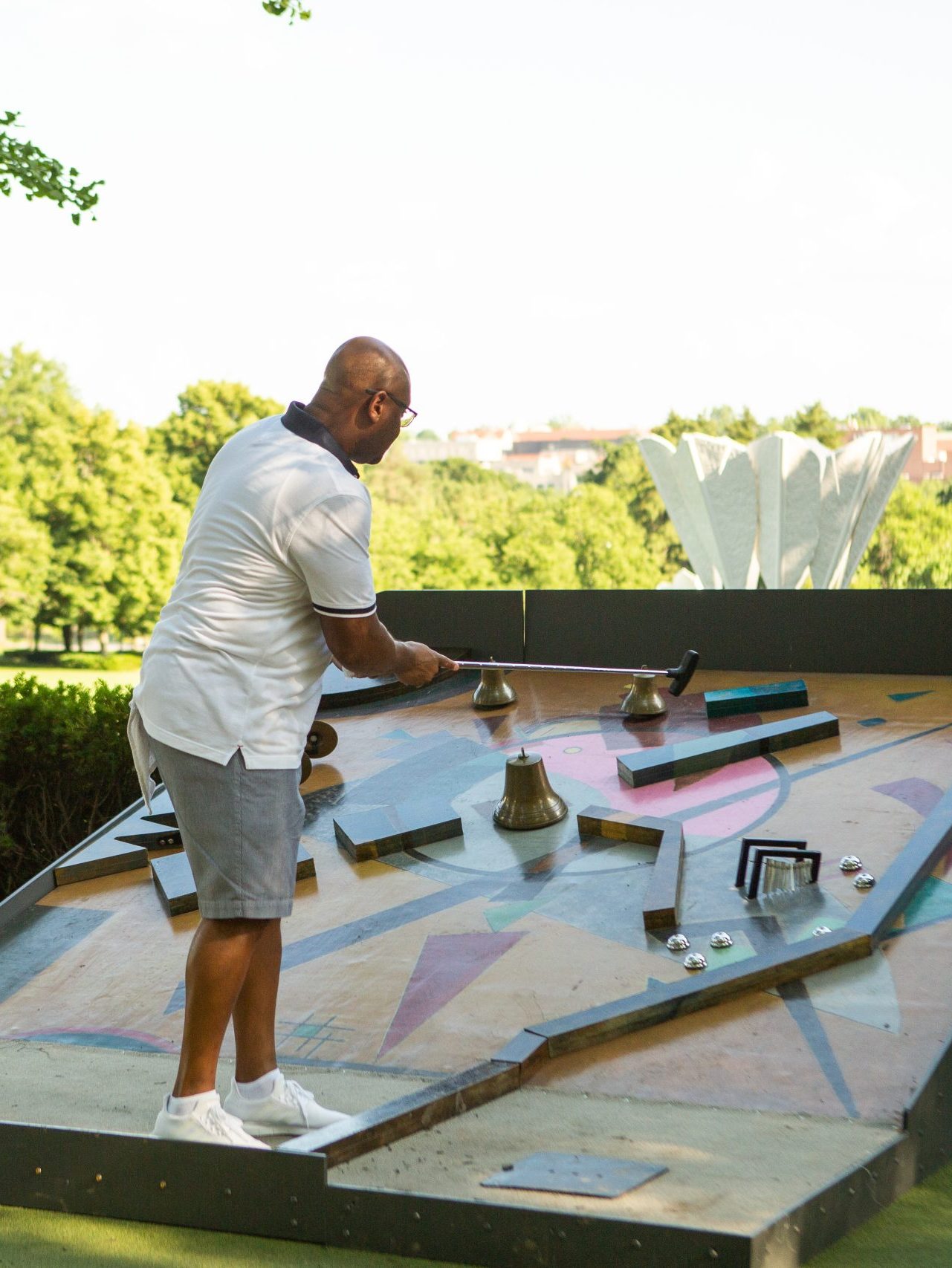 A man plays mini-golf on an art-inspired hole at the Nelson-Atkins Art Course.