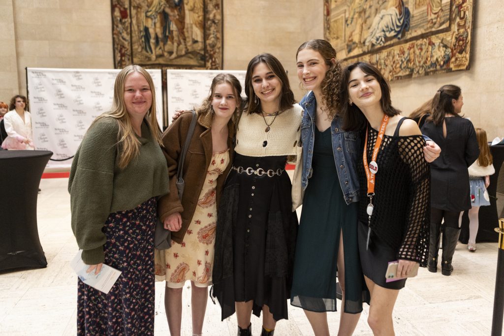 Young people pose for a photo in Kirkwood Hall at the Nelson-Atkins Teen Fashion Show.