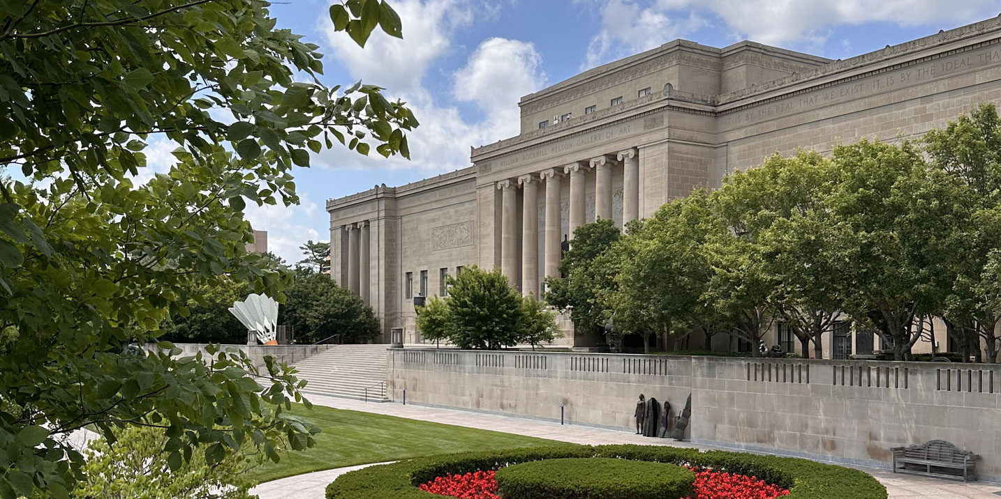 View of South entrance to the Nelson-Atkins showing lush trees, red tulips and the iconic columns of the front facade