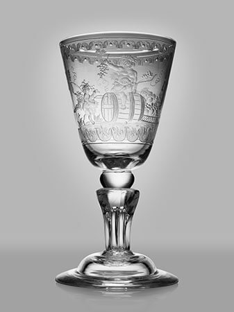 Glass goblet on gray background.