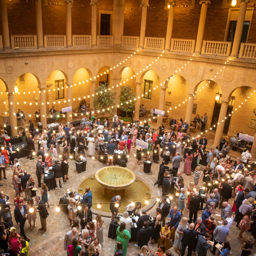 Guests gather in Rozzelle Court at the Nelson-Atkins for the ShuttleCork fundraiser.