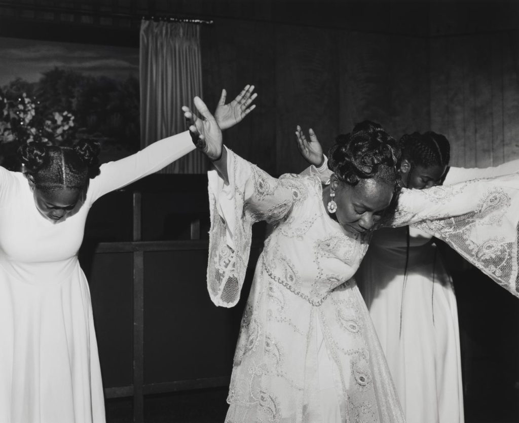 A group of women in white dresses