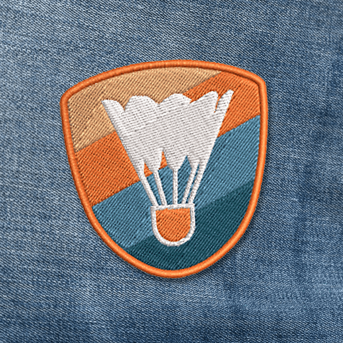 Shuttlecock patch on blue denim.