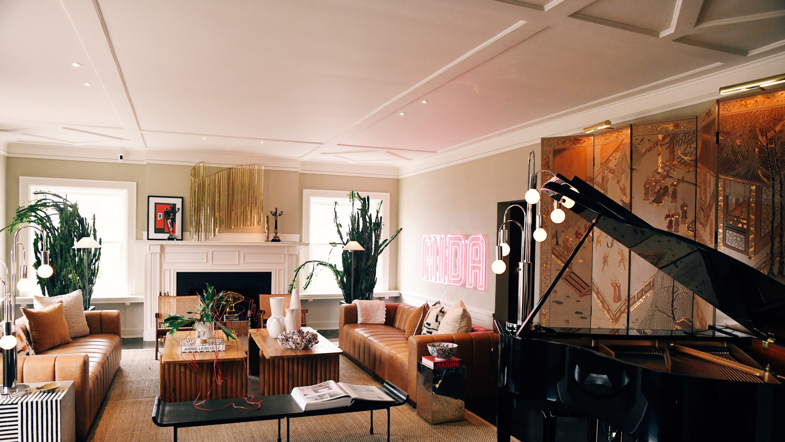Image of hotel "living room" with piano and cozy couches.