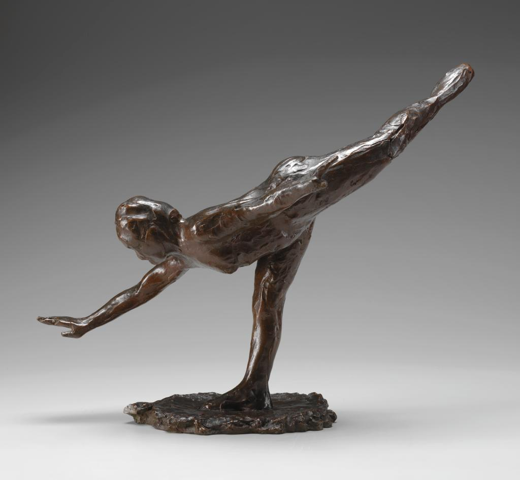 A nude female figure stands on her straightened right leg and leans down and forward; the left leg is raised high behind her with a pointed toe.