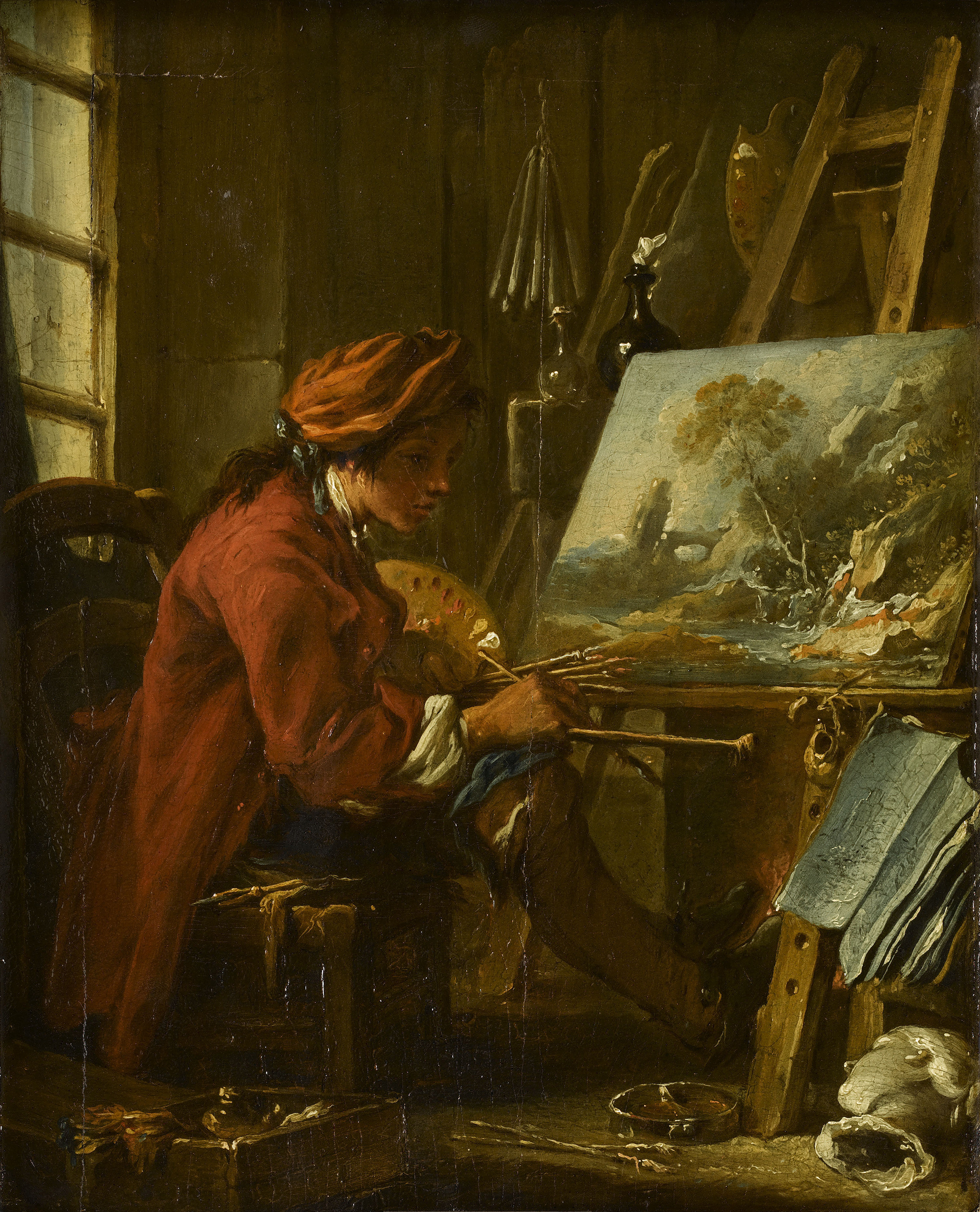 A painting of an artist sitting in a wooden chair while painting on a canvas. The artist wears a large red coat and a variety of paint brushes in his right hand. He faces a painting of a rocky mountain surrounded by a few trees. The background consists of a multiple tools and assortments hanging on the wooden wall.