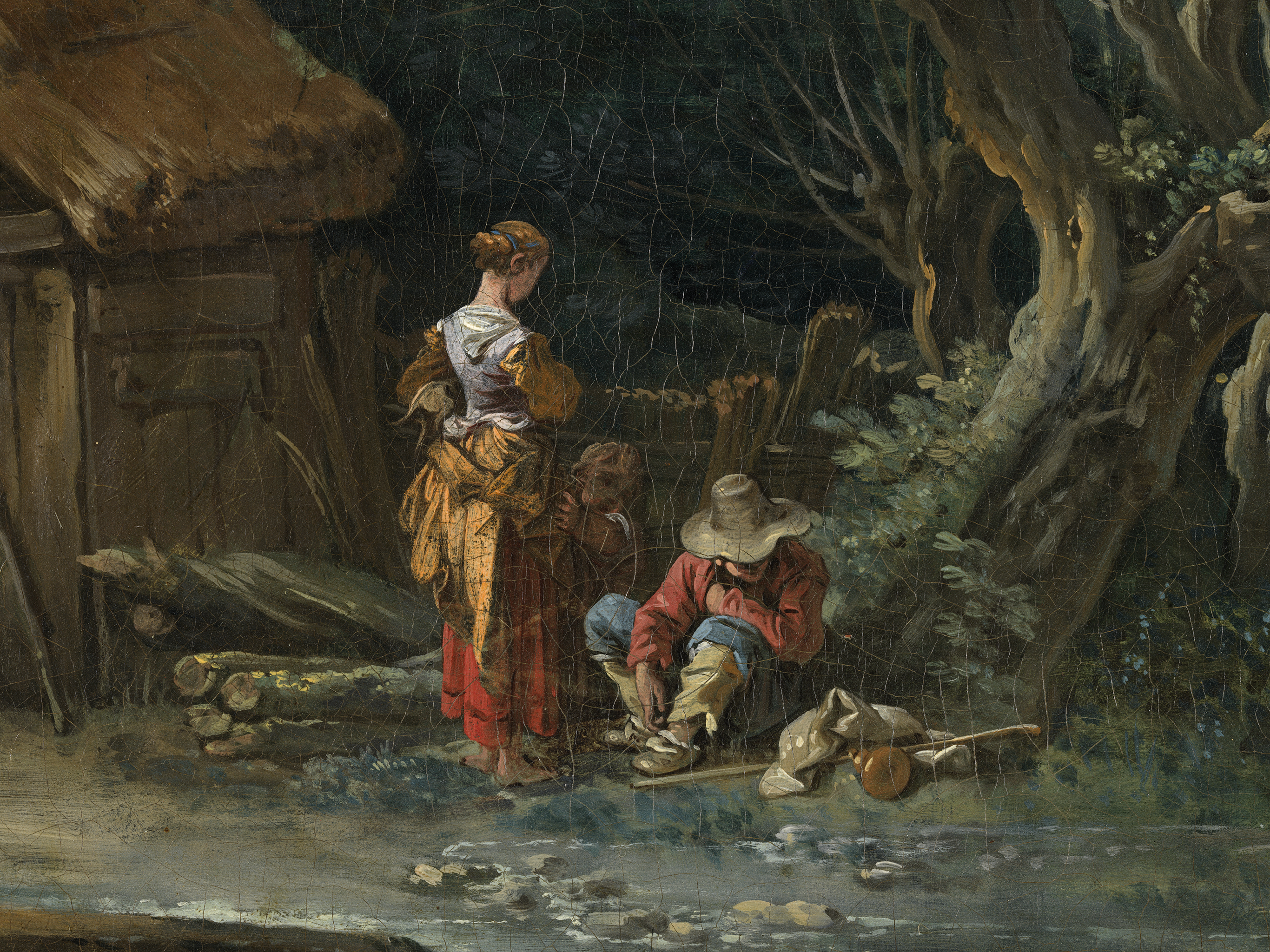 A painting depicting a group of people in a forest near a shed. A woman wearing a yellow and red dress, glances down at a child and a man leaning against the bottom of a brown tree. On the ground, there are an assortment of tools near the man’s feet. The background has the side of a shed with a hay roof next to a wooden fence.