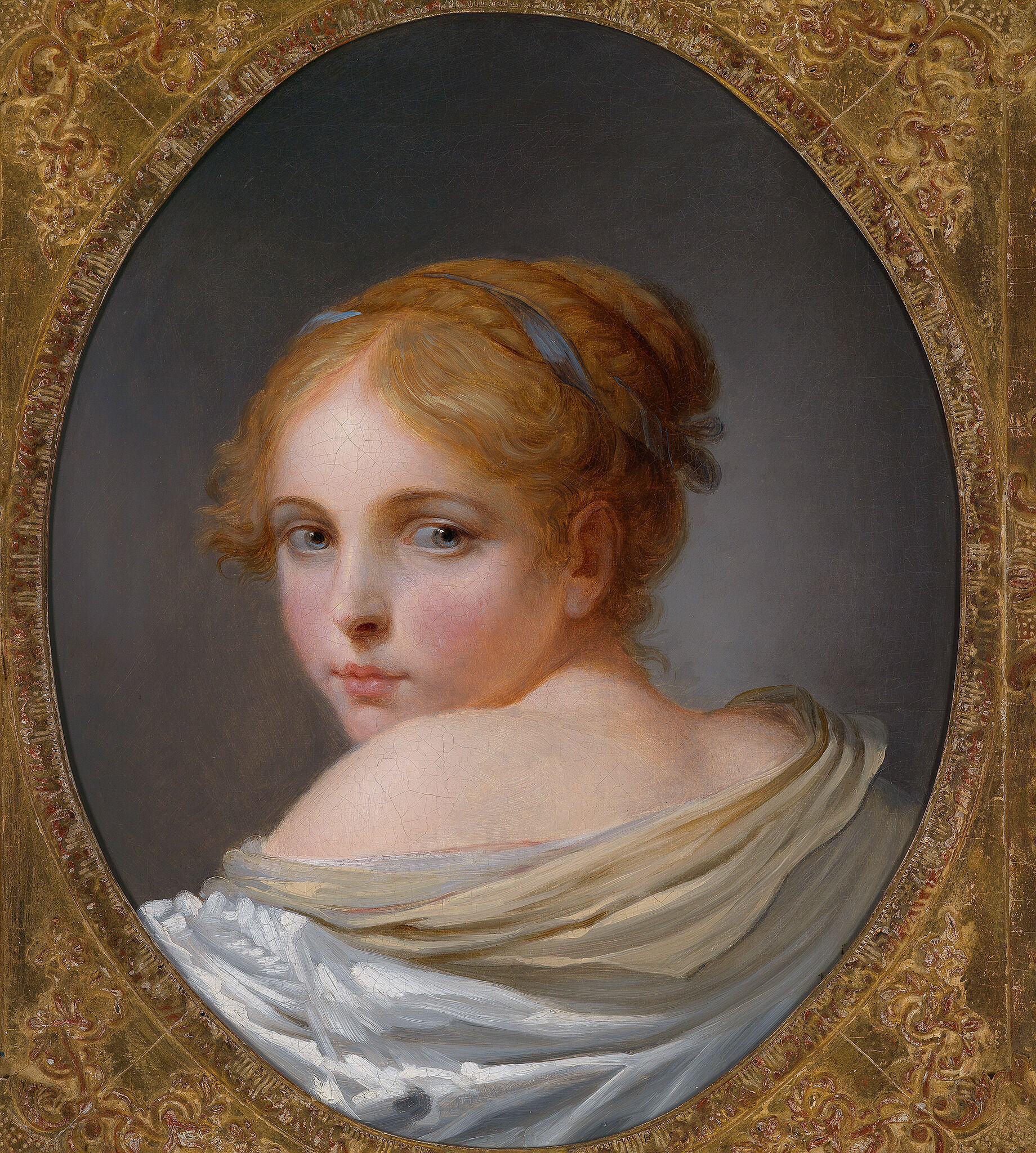A portrait of a lightly skin toned girl with her head turned over her left shoulder. She has reddish hair with a light blue tie or ribbon running through it. Her face has rosy, pink cheeks and her lips are a light red color. Her shoulder the back of her neck and her left shoulder is uncovered revealing some skin. The rest of her upper back is covered by a very light brown and white clothing. The backdrop is various shades of gray. The edges of the painting are framed in a gold design which wraps around the edges.