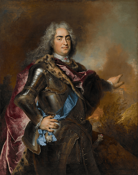 Standing portrait of a man in armor with long gray hair. He is pointing toward the right, where flames rise from a burning town.