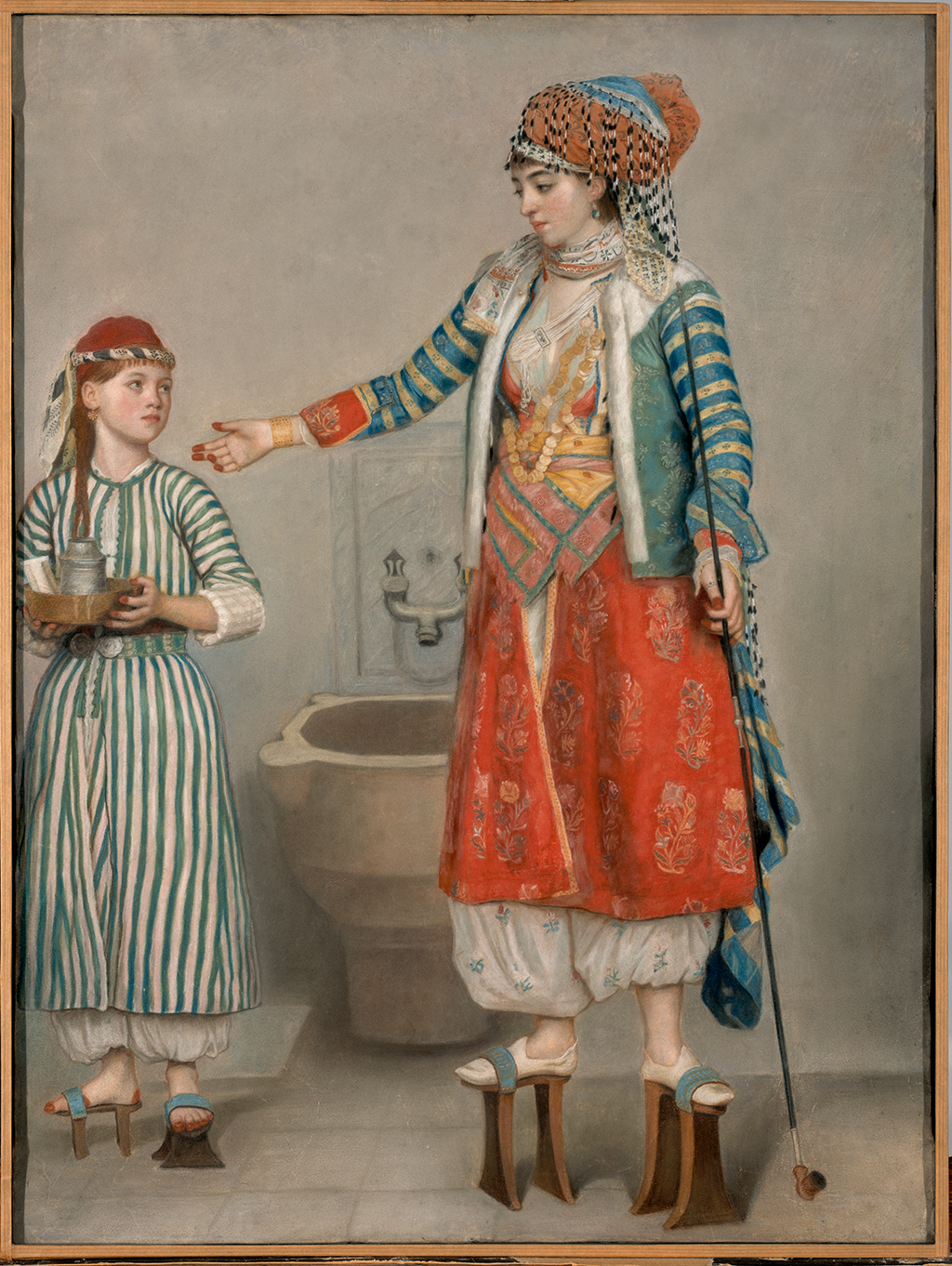 A painting of a woman and a young girl both standing on wooden hilts tied to their feet. The woman who wears red clothing reaches her hand out toward the young girl. The young girl also wears a cap and a dress with vertical stripes. She carries a bowl with a metal can inside it. In the background there is a sink sculpted into the wall. The painting is also surrounded by a light brown frame.