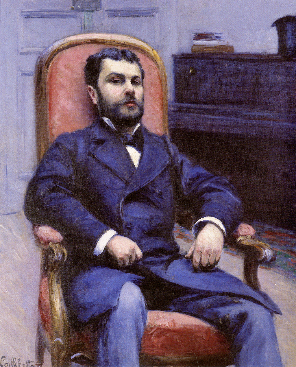 A painting depicting a man slouching back in a wooden chair with a red back cushion. He wears a black suit with a black tie. His arms lay on the resting on the armrests of the chair. In the background, there is black cabinet next to a white door.
