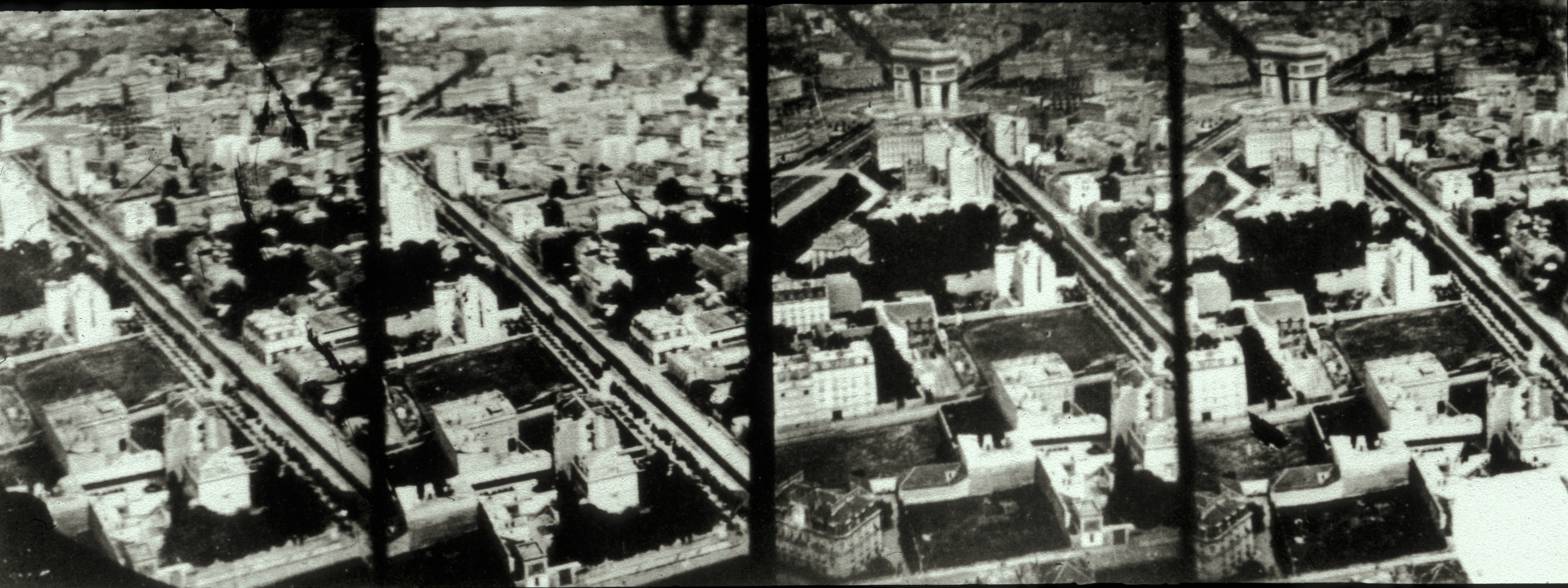 Four black and white photographs next to each other which each depict a top-down view of a series of buildings and roads.