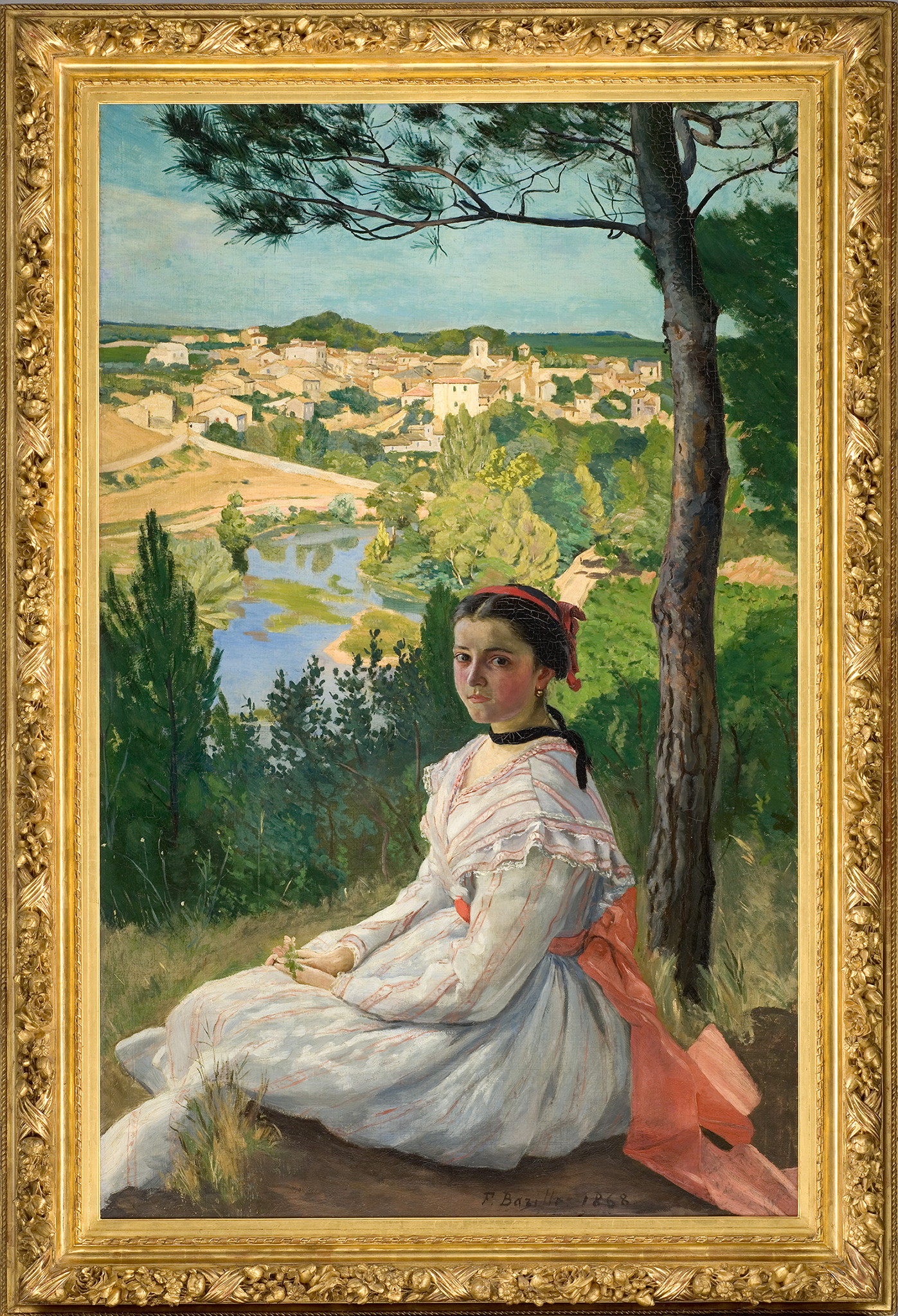 A painting of a girl wearing a white dress with oranges strips and tie around her waist. She sits with her hands on her lap along the grass under a tree. In the background, there is a is a lake in front of a large town.