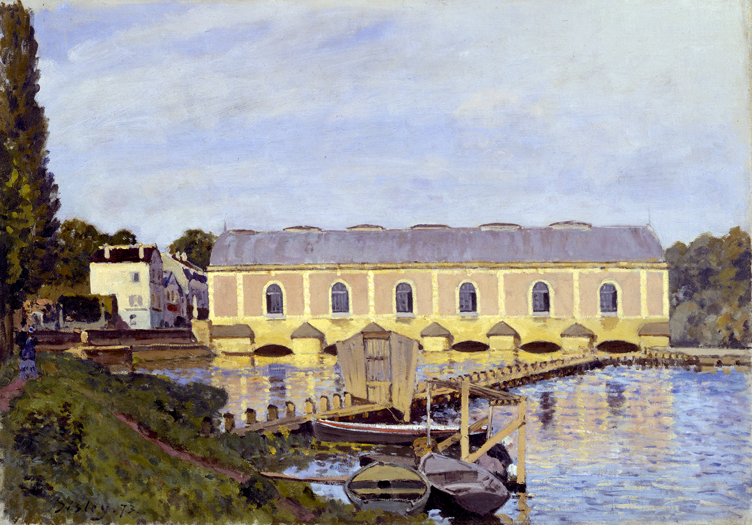 A painting of three small wooden boats in a river while a thin wooden bridge crosses over it. The boats rest against a bank covered in green grass with a brown trail. Behind the wooden bridge, there is a long yellow building with six windows. Behind it, there are white buildings that leads to a small town. The sky above is light blue.