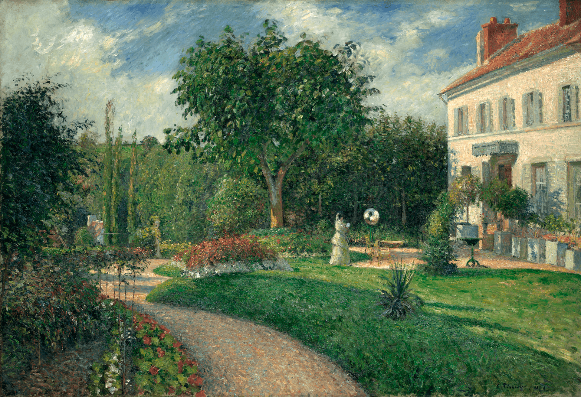 A path leads through a blooming garden. A white house is at the right and a woman stands before it