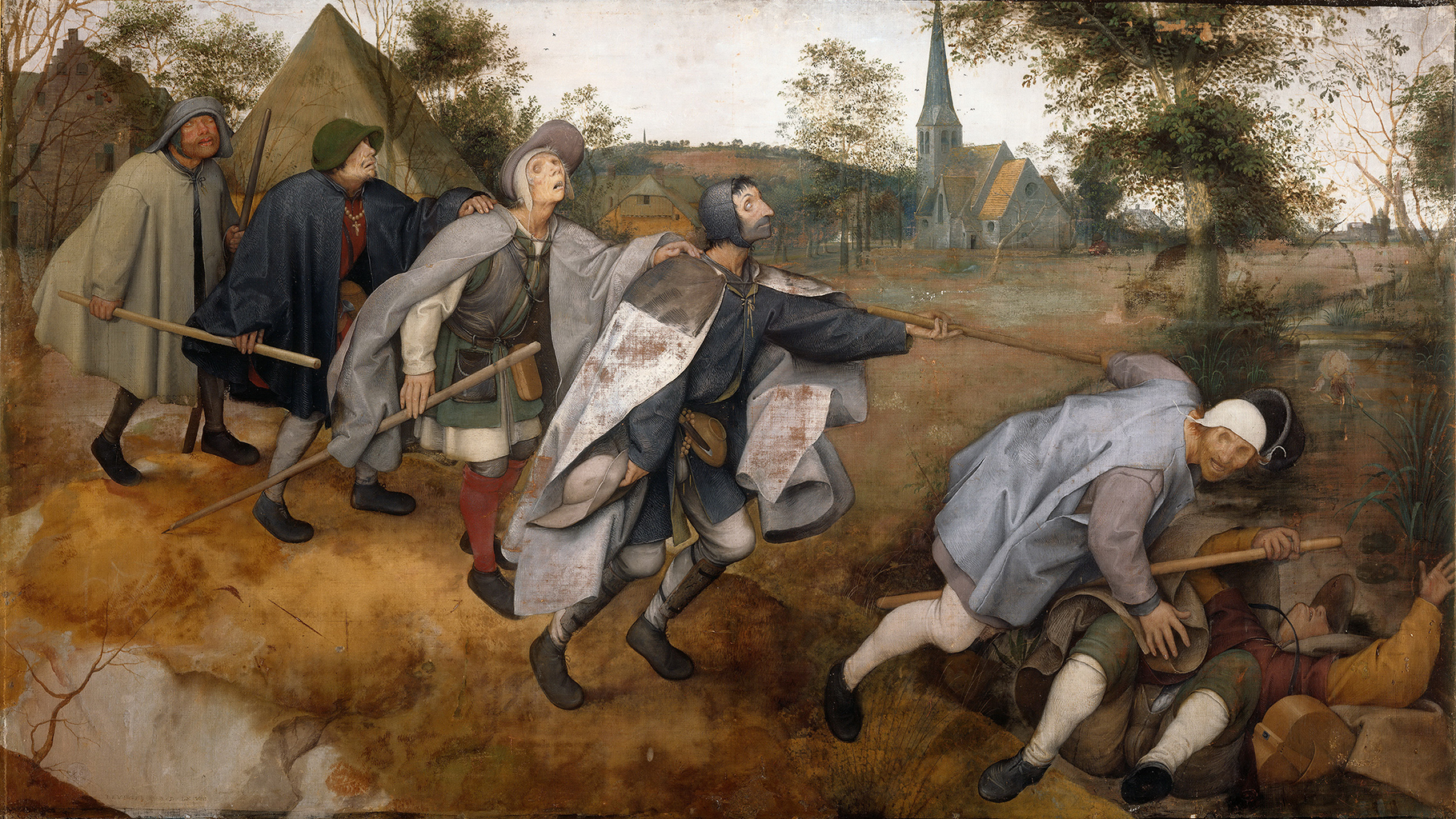 A painting that is depicting a group of six people wearing large coats or capes with hats, walking in a single file line. At the front of the line, a man wearing green, red, and orange, has fallen over on his back. A man wearing gray seems to be stumbling over them. The man at the back holds a stick that the one in front of him, and the other three men have their hands on each other shoulders. In the background, there seems to be a variety of buildings in a town along with trees and hills. Behind them is a small village surrounded by hills and trees.