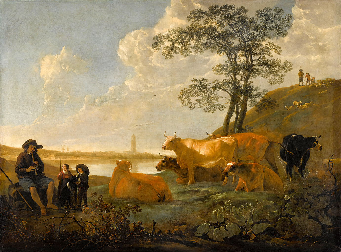 A painting depicting a herd of cattle resting near a two trees and hilly cliff side with a small group standing at the top. On the left side, a man wearing a brown hat and shirt with blue shorts sits on a stack of rocks and plays a wooden shawm instrument. Near him, are two young children with a black and white dog. The little girl holds a long walking stick while the boy stands next to her seemingly patting a dog. Behind them, is a large lake, with another land with a tower standing across it.