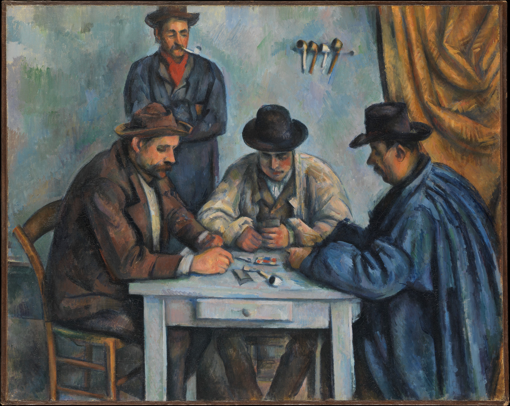 A painting depicting three men sitting down at a small white table playing a game of cards. The men wear brown, white, and blue coats along with brown and black brimmed hats. They focus on the cards in their hand and on the table. In the background, there is a man against the light blue and green wall smoking a pipe. To his right is a stand holding four other pipes and a large golden cloth hanging.