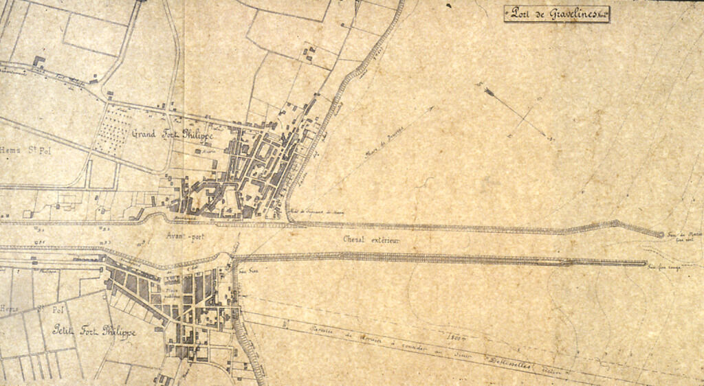 A photograph of a top-down view of a map depicting a river cutting a town in two. There are also labels on different sections of the map.