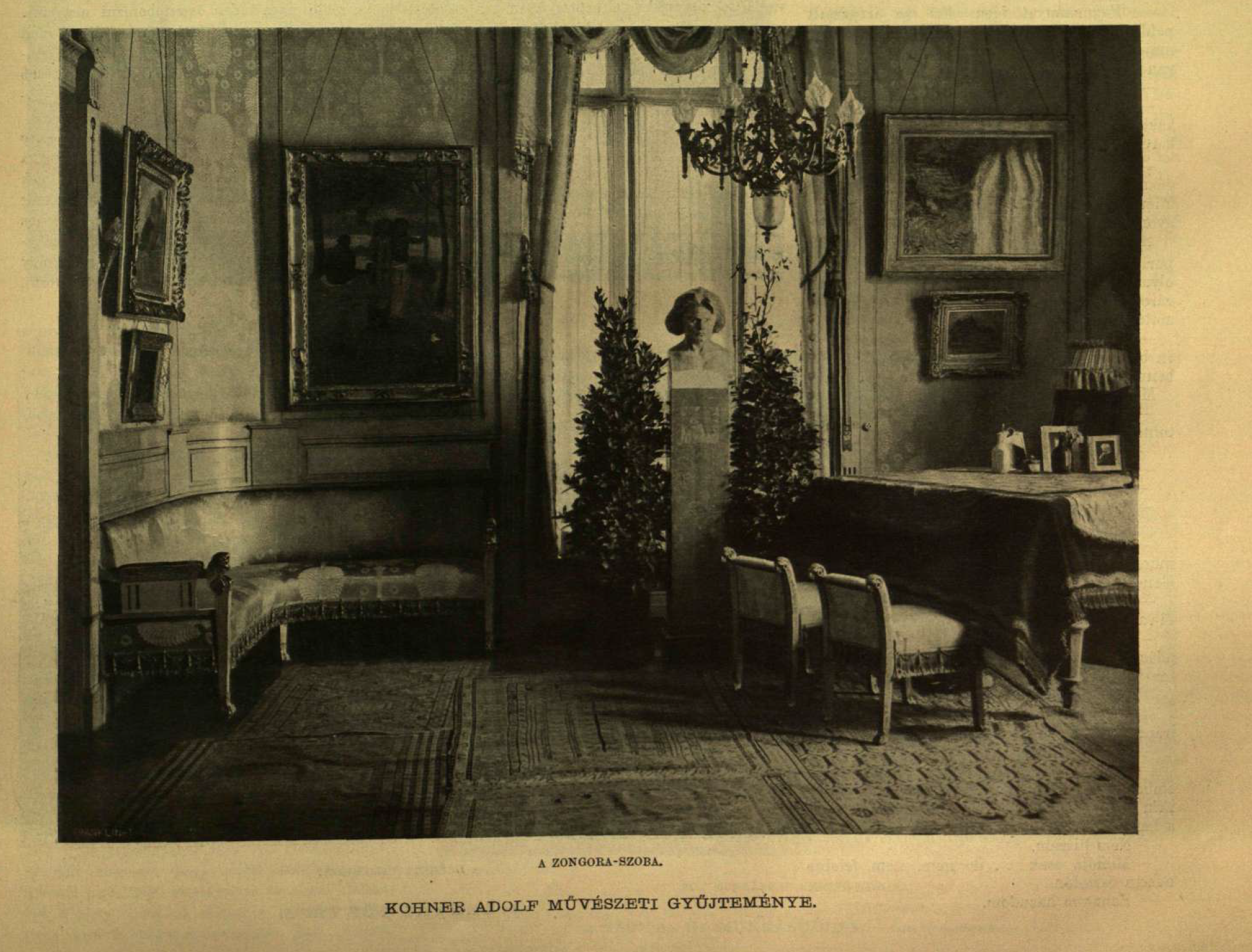 A black and white photograph depicting a room with a large window in the middle. On the right side of the window, there are two small chairs that are resting underneath a table with a cloth draped over it. Above the table are two paintings which hang on the wall. On the left side of the window, there is a curved couch or bench. Above it is three framed paintings. A chandelier hangs from the ceiling.