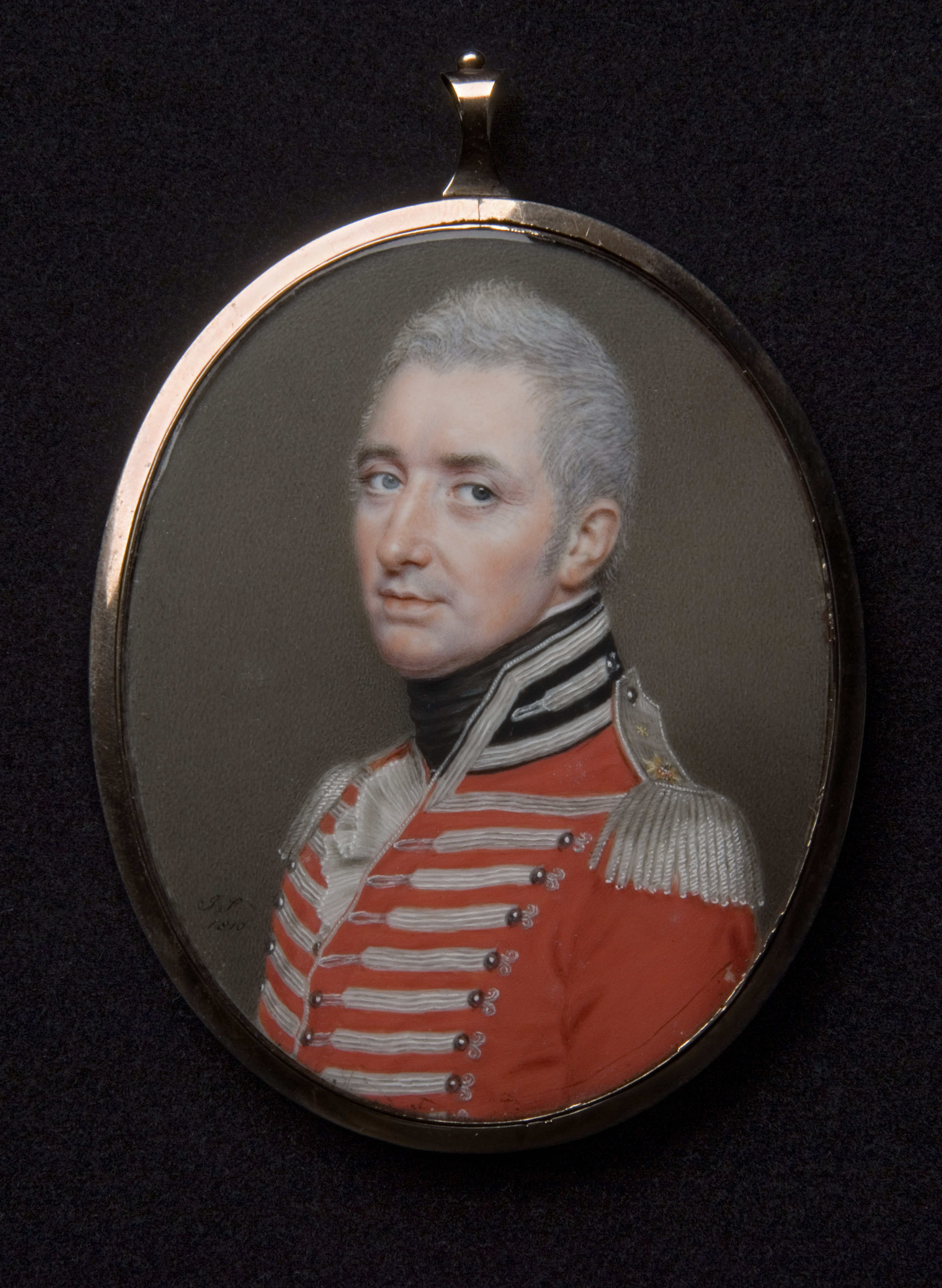 Portrait miniature of a light-skinned man wearing a red military coat before a gray background.